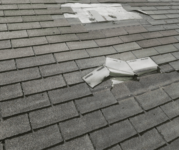 Missing and damaged shingles on roof from wind